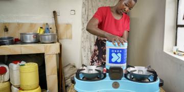 A-KOKO-customer-in-Nairobi-adding-fuel-to-her-KOKO-Cooker-at-home